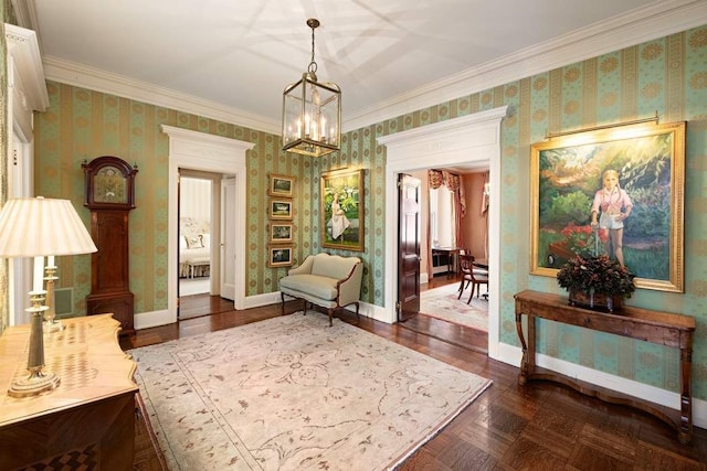 sitting room featuring ornamental molding, dark parquet floors, and a chandelier