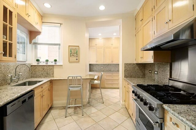 kitchen with dishwashing machine, sink, stainless steel gas range oven, and light stone countertops