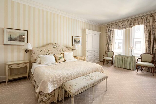 bedroom with crown molding and carpet floors