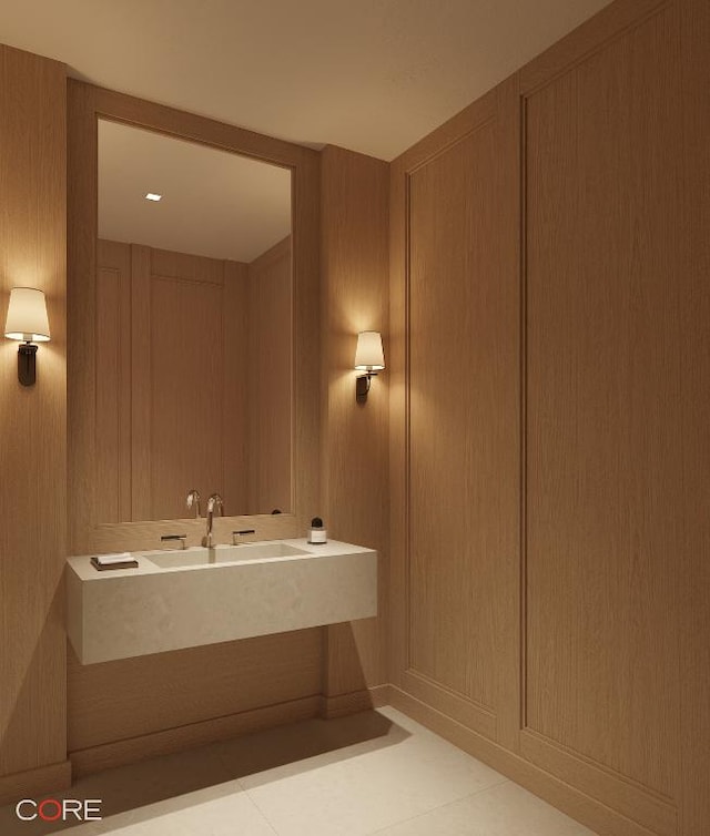 bathroom with tile patterned floors and wood walls