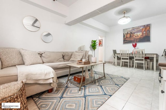 tiled living room featuring beam ceiling