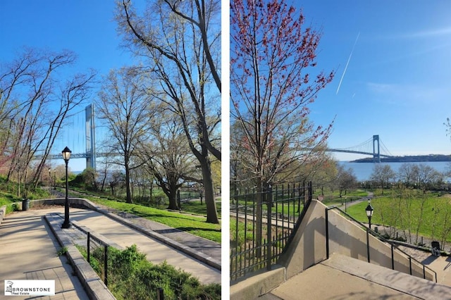 view of home's community with a lawn and a water view