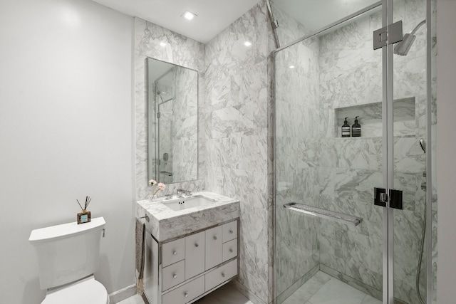 bathroom with an enclosed shower, vanity, and toilet