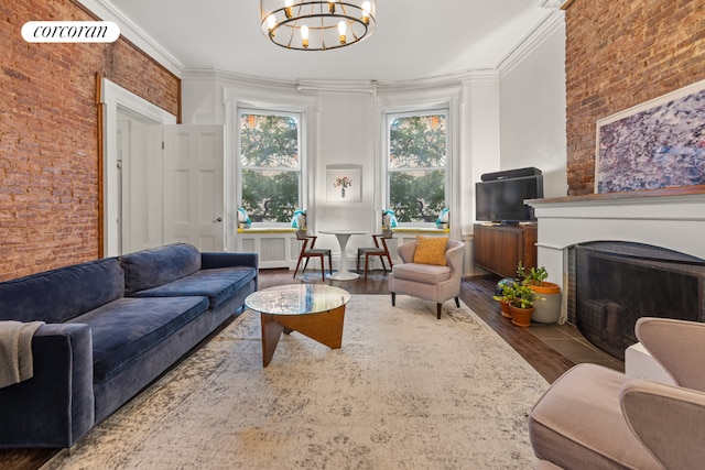 living room featuring brick wall, wood finished floors, visible vents, and crown molding