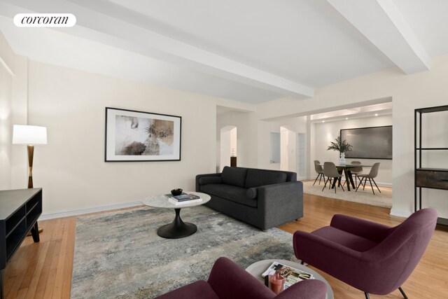 living room with wood-type flooring and beamed ceiling