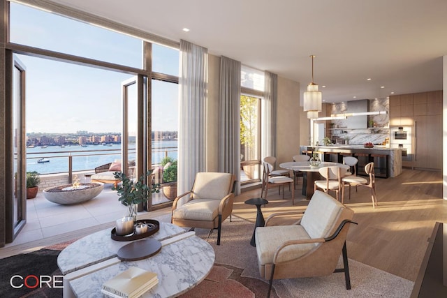 living room featuring a water view and a wall of windows