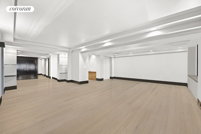 interior space featuring elevator and light hardwood / wood-style flooring