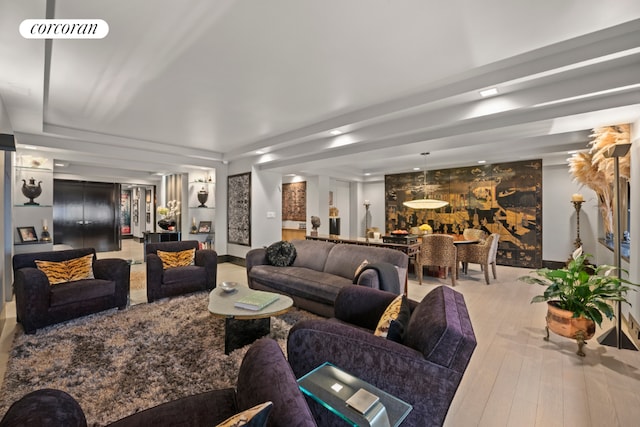 living room featuring light hardwood / wood-style flooring and a raised ceiling