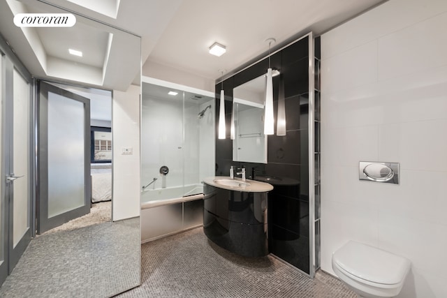 full bathroom with toilet, combined bath / shower with glass door, and vanity