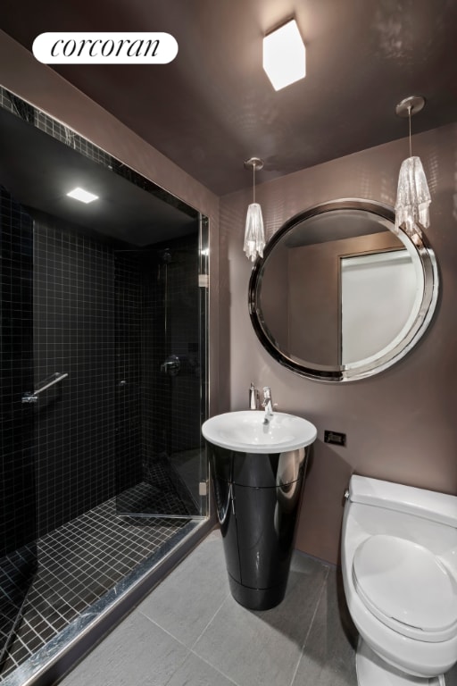 bathroom with toilet, tile patterned flooring, and an enclosed shower