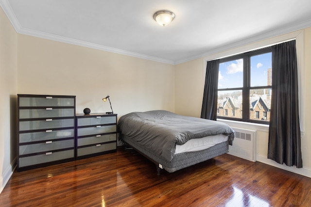 bedroom featuring crown molding, wood-type flooring, and radiator