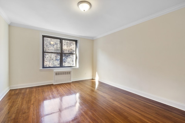 unfurnished room with ornamental molding, radiator, baseboards, and wood finished floors