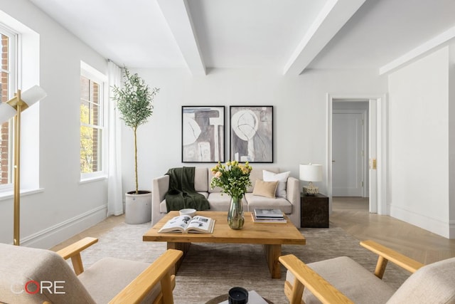 living room featuring beamed ceiling and light parquet floors