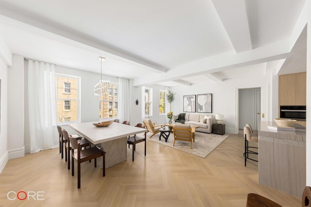 dining space with a wealth of natural light, a notable chandelier, baseboards, and beam ceiling