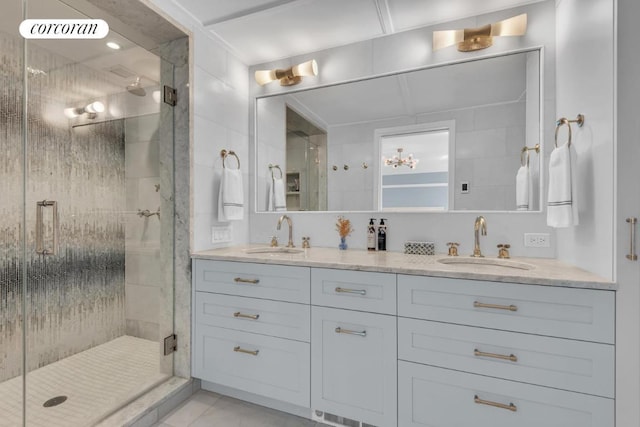 bathroom with walk in shower, vanity, and tile patterned floors