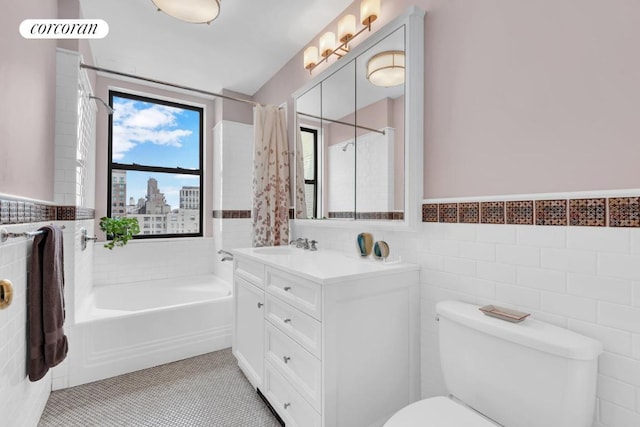 bathroom featuring toilet, tile walls, tile patterned flooring, and vanity