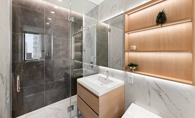 bathroom featuring tile walls, an enclosed shower, and vanity