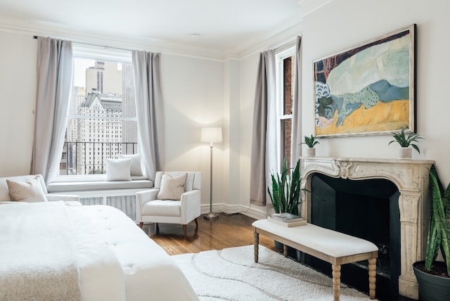 bedroom with hardwood / wood-style flooring and ornamental molding