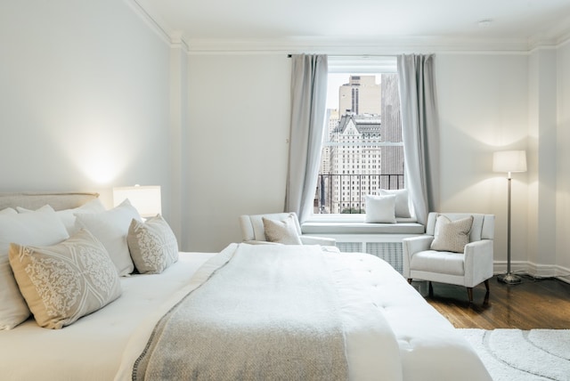 bedroom featuring hardwood / wood-style flooring and ornamental molding