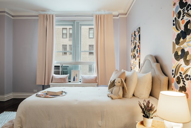 bedroom with wood-type flooring and ornamental molding