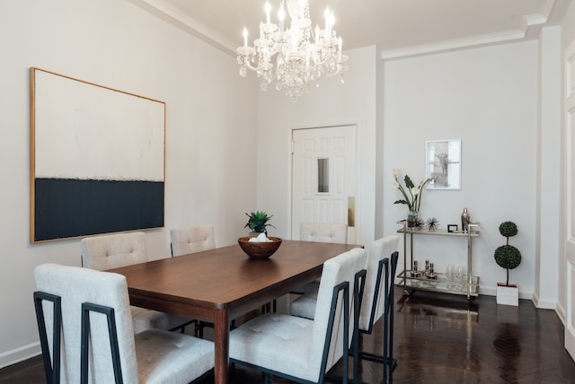 dining space with crown molding, dark wood-type flooring, and an inviting chandelier