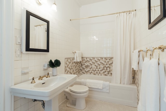 bathroom with tasteful backsplash, tile walls, tile patterned flooring, toilet, and shower / bath combo