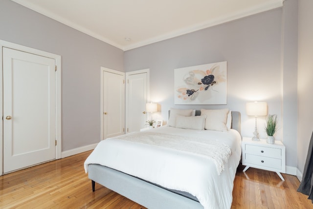 bedroom featuring crown molding and hardwood / wood-style floors