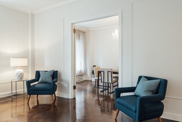 sitting room with crown molding, dark parquet floors, and a notable chandelier