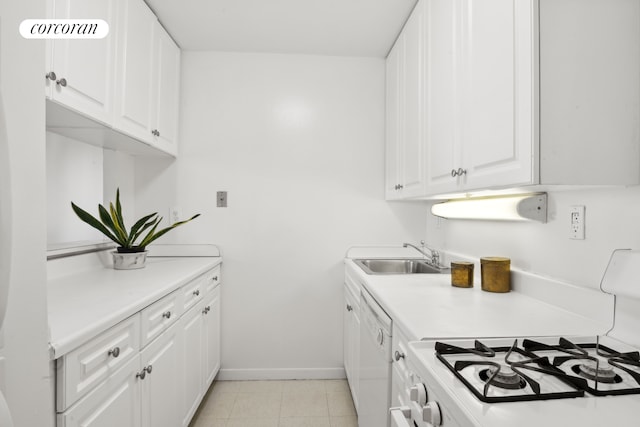 kitchen featuring light countertops, white appliances, white cabinetry, and a sink