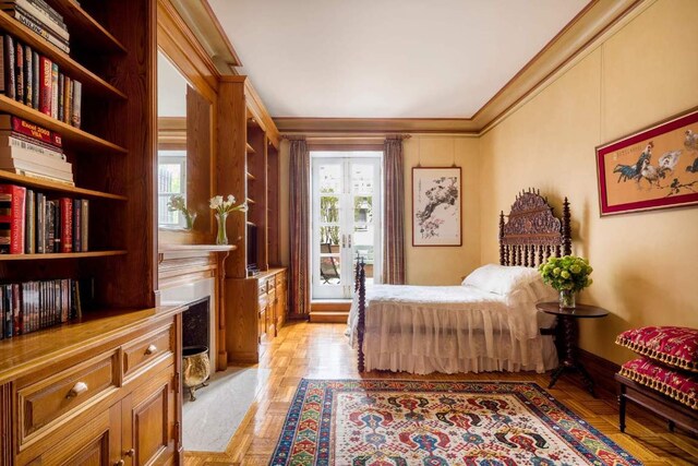 bedroom with ornamental molding and light hardwood / wood-style floors