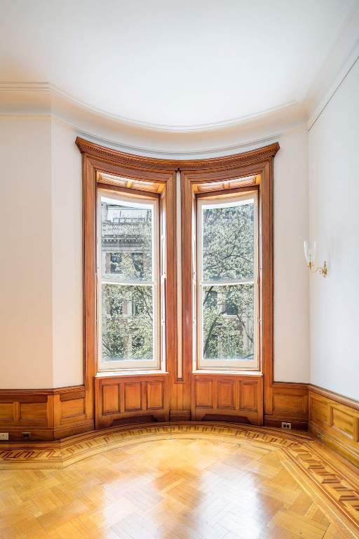 interior space featuring light parquet floors and crown molding