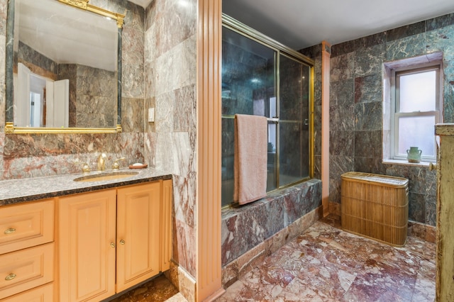 full bathroom with a shower, tile walls, and vanity