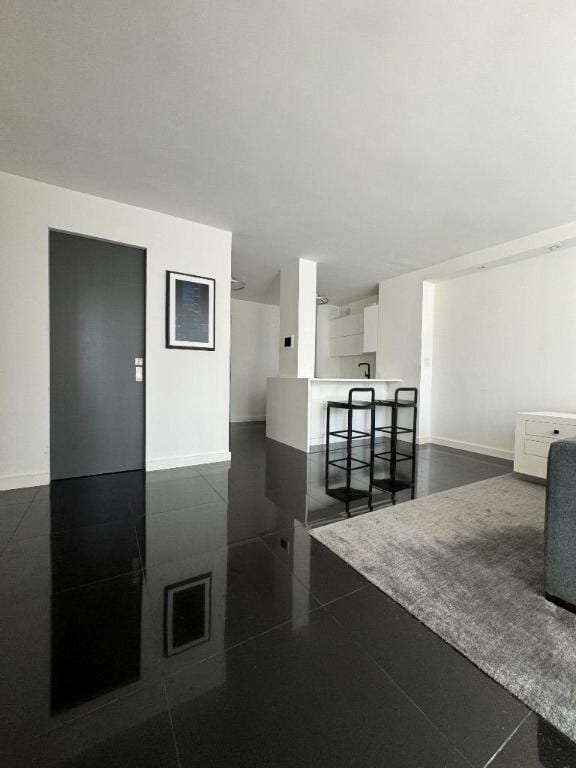 interior space with baseboards and white cabinets