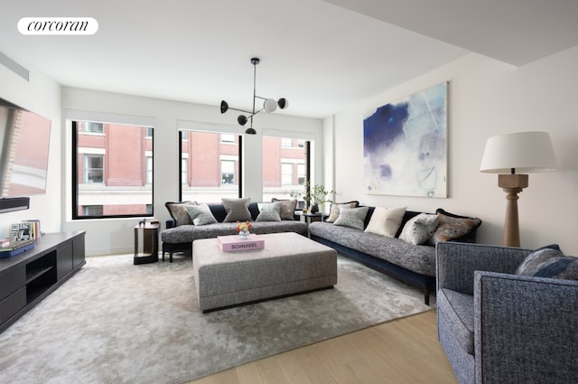 living room with a wealth of natural light and light hardwood / wood-style floors