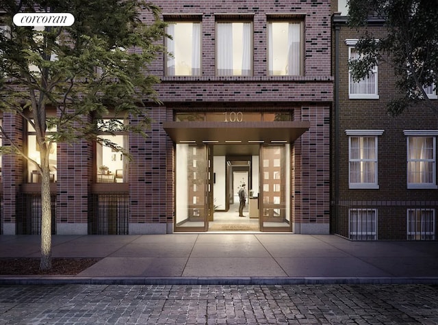 entrance to property featuring brick siding