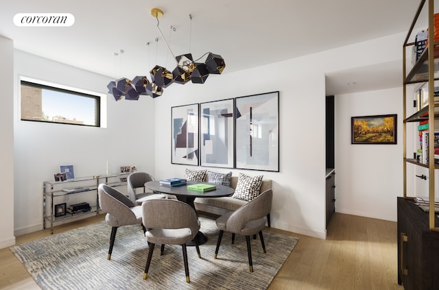 dining space with light wood-type flooring, baseboards, and visible vents