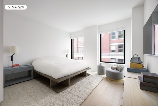 bedroom with visible vents and wood finished floors