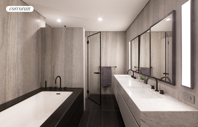 bathroom with a freestanding tub, a walk in shower, a sink, and tile patterned floors