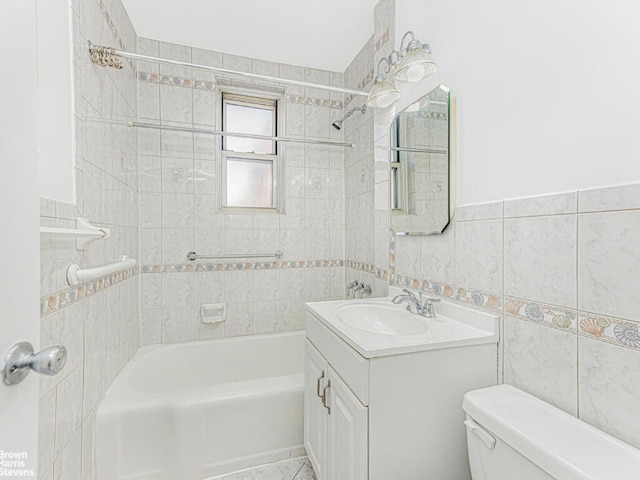 bathroom with shower / bathing tub combination, tile walls, toilet, and vanity