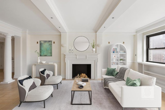 living room featuring crown molding, built in features, light parquet flooring, and decorative columns