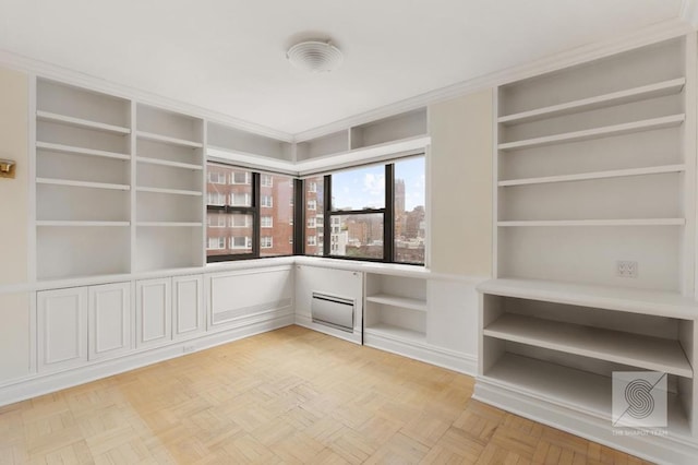 empty room with light parquet flooring and built in shelves