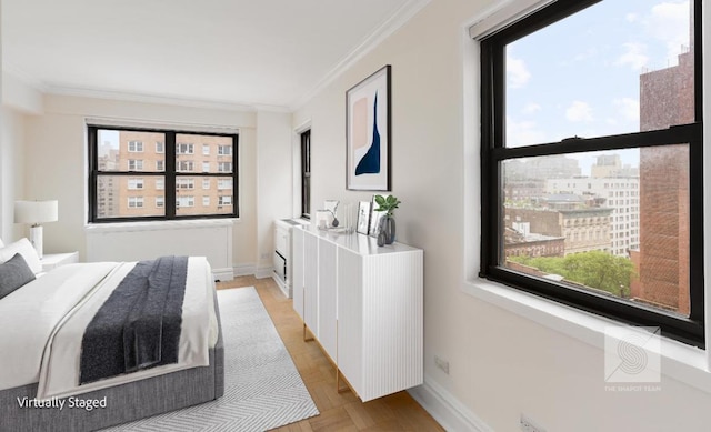 bedroom with light parquet flooring and ornamental molding