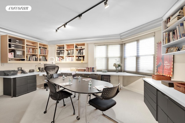 office featuring light colored carpet, visible vents, ornamental molding, built in study area, and track lighting