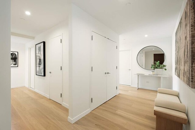 bedroom featuring an inviting chandelier, radiator heating unit, and light wood-type flooring