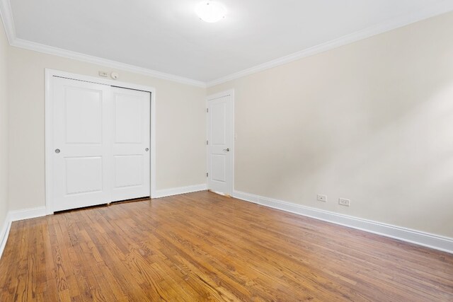 bedroom with hardwood / wood-style flooring, radiator heating unit, and ornamental molding