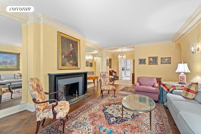 living area with visible vents, a fireplace, an inviting chandelier, and ornamental molding