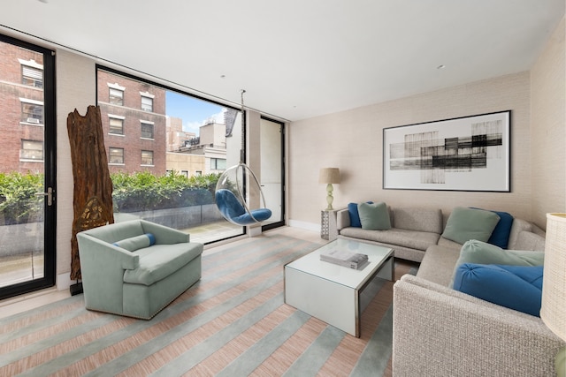 116 E 61st St, New York City, NY 10021 - living area with healthy amount of natural light, wood finished floors, and baseboards