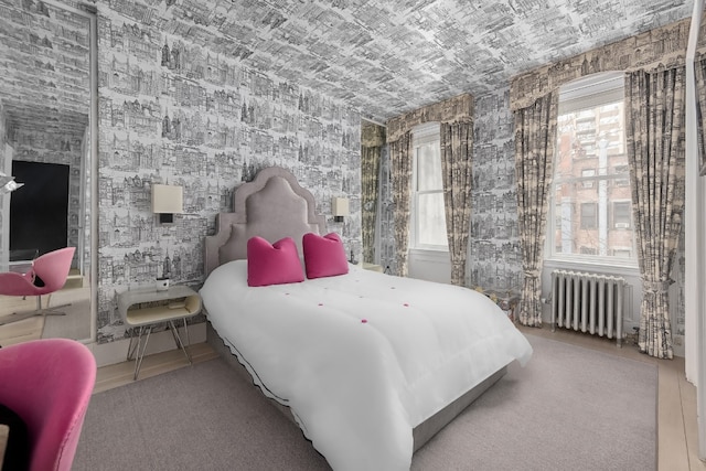 bedroom featuring radiator and tile patterned floors