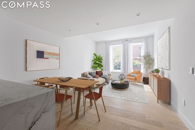 dining space featuring light wood-type flooring