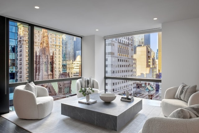 living area with a wall of windows, a view of city, and recessed lighting